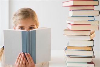 Portrait of girl (8-9) reading book