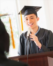 Young man giving speech at graduation
