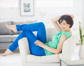 Portrait of cheerful woman relaxing at home