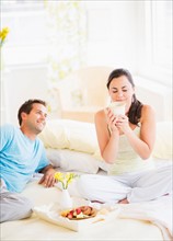 Woman and man having breakfast in bed