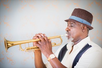 Portrait of man playing trumpet