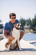 Portrait of young man posing with his dog