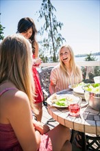 Young women enjoying outdoor meal