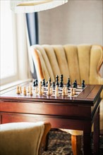 Empty room with armchairs and chess