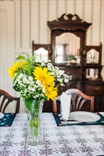 Close-up of flowers in vase on table in dining room