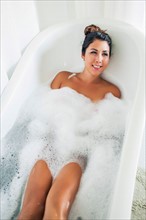 Portrait of woman in bubble bath