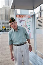 Senior man standing at bus stop