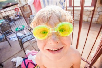 Boy (4-5) posing in swimming goggles