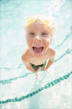 Boy (4-5) posing in swimming pool