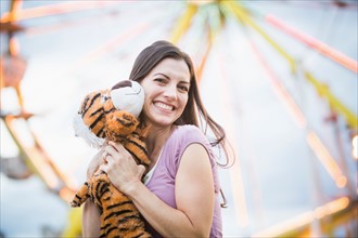 Portrait of woman with toy tiger