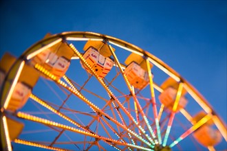 Ferris wheel in amusement park at dusk