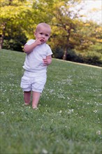 Baby (12-17 months) playing in park
