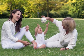 Three generation family playing in park