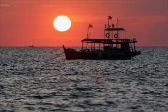 Trawler against setting sun