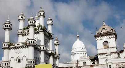 Devatagaha Mosque and town hall against cloudy sky