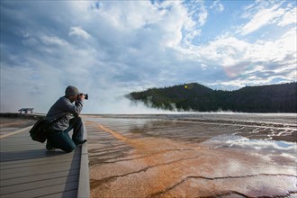 Man photographing Grand Prismatic Geyser