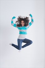 Studio Shot of girl (12-13) jumping