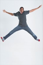 Studio Shot of teenage boy (14-15) jumping