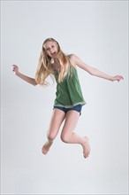 Studio Shot of teenage girl (14-15) jumping