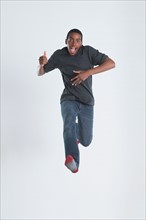 Studio Shot of teenage boy (14-15) jumping