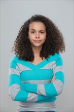 Portrait of girl (12-13) with arms crossed