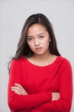 Portrait of teenage girl (16-17) with arms crossed