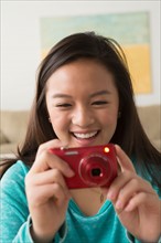 Portrait of teenage girl (16-17) with digital camera