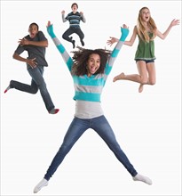 Studio shot of four friends (12-13,14-15) jumping on white background
