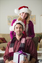 Portrait of young couple wearing santa hats