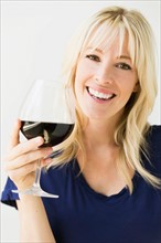 Studio portrait of blonde woman with wineglass