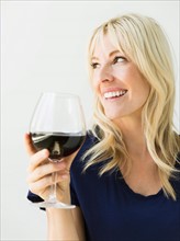 Studio portrait of blonde woman with wineglass