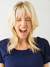 Studio portrait of blonde woman screaming