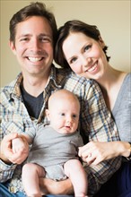 Portrait of parents with baby son (2-5 months)