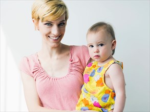 Portrait of mother holding daughter (12-17 months)