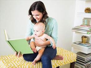 Mother with son (6-11 months) reading book