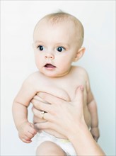 Baby boy (6-11 months) held by adult