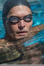 Portrait of swimmer wearing cap and goggles.