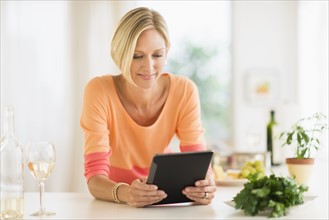 Woman using tablet pc at home.