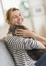 Portrait of woman holding cat.