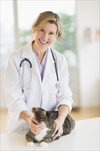 Portrait of female vet with cat.