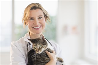 Portrait of female vet with cat.