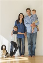 Portrait of parents with two sons (12-17 months, 6-7) and dog.