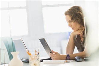 Business woman using digital tablet and laptop.