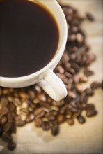 Studio shot of cup of coffee and roasted coffee beans.
Photo : Jamie Grill