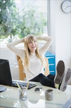 Female designer relaxing in office.
Photo : Jamie Grill