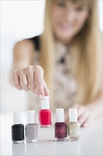 Woman choosing nail polish.
Photo : Jamie Grill
