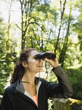 Portrait of woman looking at view with binoculars. USA, Oregon, Portland.