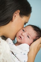 Portrait of mother holding newborn baby (0-11 months).