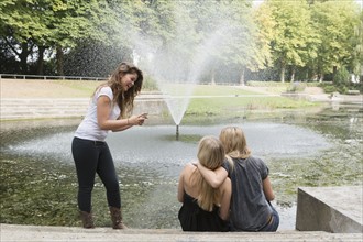 Female friends using cell phone. Netherlands, Groningen.
Photo : Jan Scherders