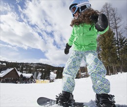 Girl on snowboard. USA, Montana, Whitefish.
Photo : Noah Clayton